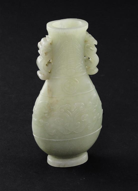 A Chinese celadon jade archaistic flattened pear shape vase, Qianlong / Jiaqing period, 10.9cm